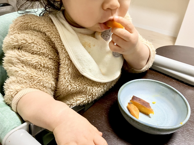 手掴みで食べる子ども