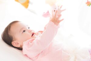 仰向け姿勢で遊ぶ赤ちゃん